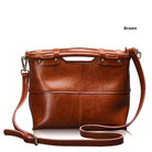 Brown leather handbag with a strap on a white background
