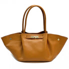 Brown leather handbag with gold accents on a white background