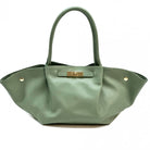 Green handbag with a gold clasp on a white background