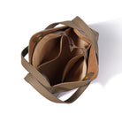 Brown leather handbag with a shoulder strap on a white background