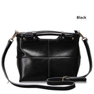 Black leather handbag with a shoulder strap on a white background