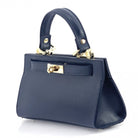 Blue handbag with gold accents on a white background