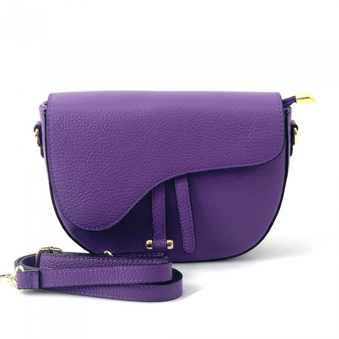 Purple leather handbag with a matching strap on a white background