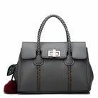 Gray handbag with braided handle and decorative pom-pom on a white background