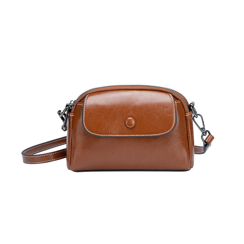 Brown leather handbag with a chain strap on a white background