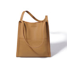 Brown leather tote bag on a white background