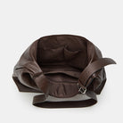 Brown leather handbag with a strap on a white background