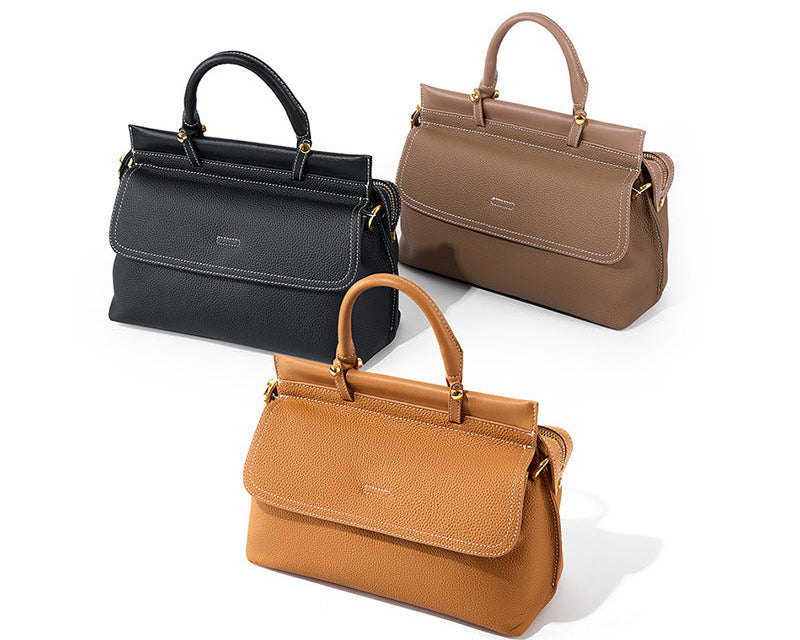 Three handbags in black, brown, and tan on a white background