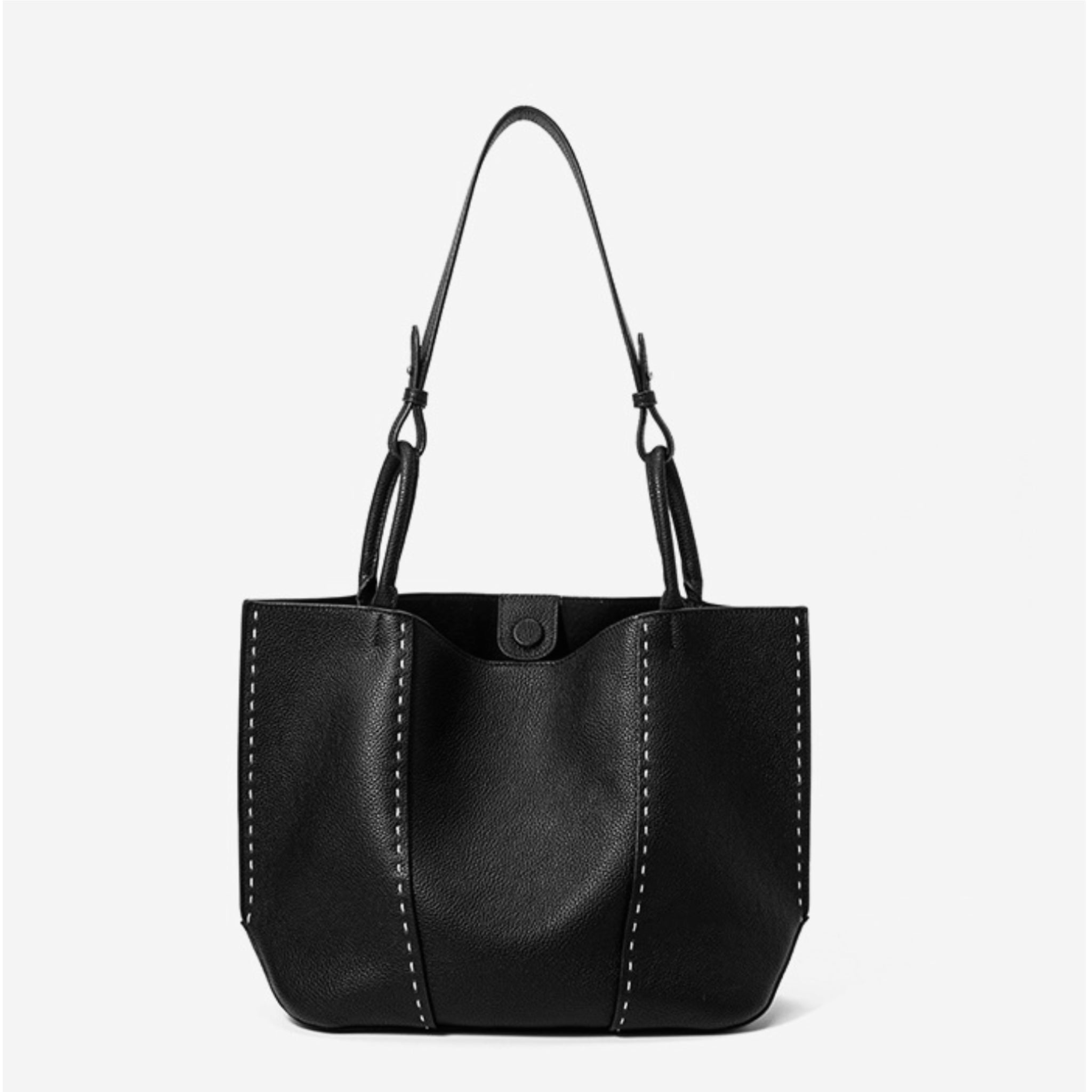 Black leather handbag with a strap on a white background