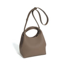 Brown handbag with a strap on a white background