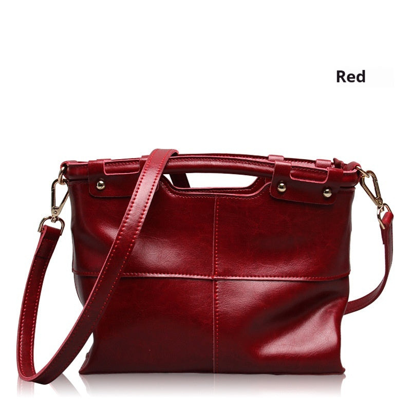 Red handbag with gold accents on a white background