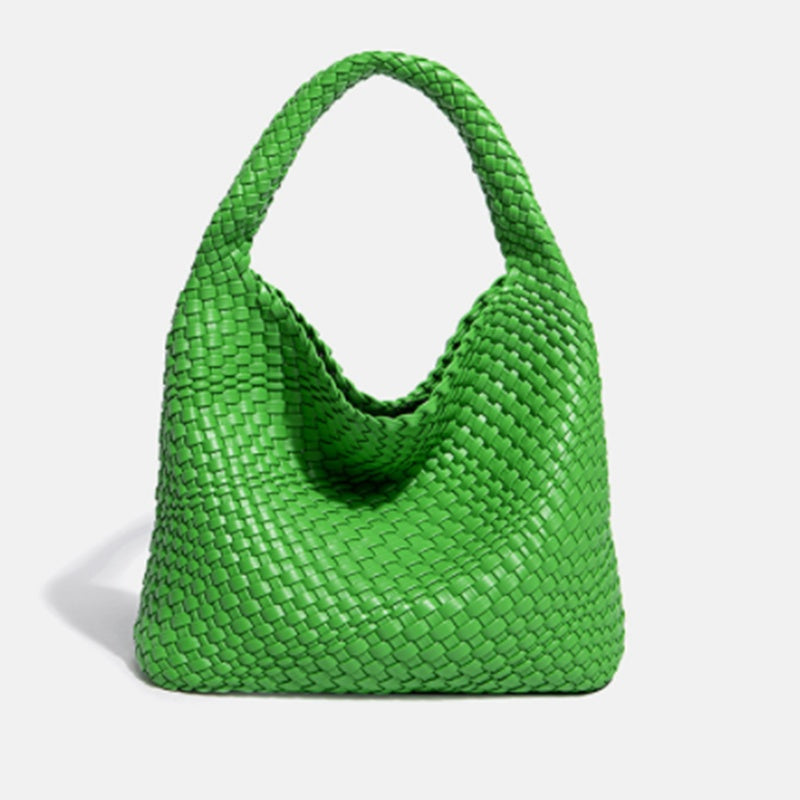 Green woven handbag on a light gray background
