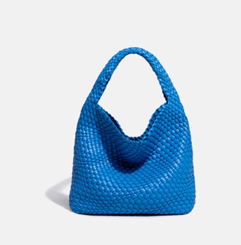 Blue woven handbag on a light gray background