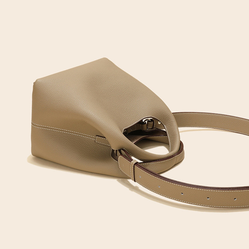 Beige handbag with a strap on a beige background