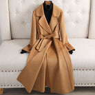 Tan coat with a belt on a white sofa